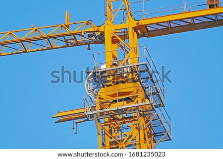 Similar – Image, Stock Photo Yellow construction crane and tree trunks in front of a blue sky