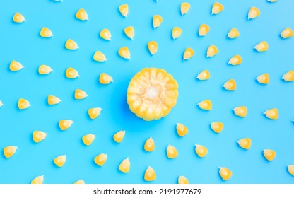 Yellow Corn Cob Slice With Scattered Seeds On Blue Background