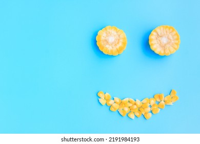 Yellow Corn Cob Slice And Seeds On Blue Background, Smile Face