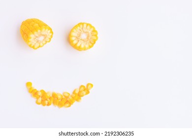 Yellow Corn Cobs Slice And Seeds On Pink Background, Smile Face	