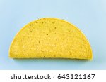 Yellow corn taco shells on a blue background.