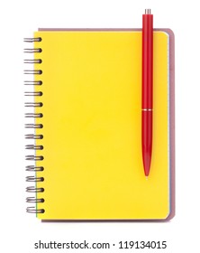 Yellow cover notebook with red pen isolated on white background cutout