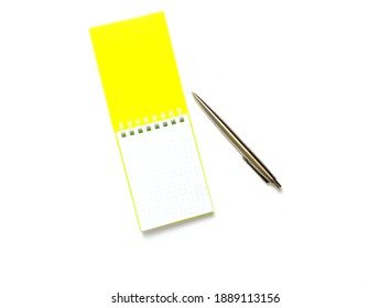 Yellow Cover Notepad With Metal Pen Isolated On White Background. Flat Lay.