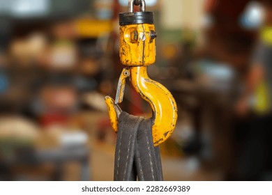 Yellow crane hook with belt in factory industry background
 - Powered by Shutterstock