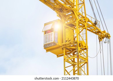 Yellow Crane On A White Sky Background.Technology Equipment For Transportation For Bring Construction Materials To Over Or High Construction Site.