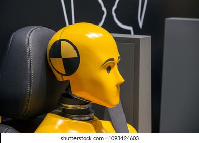 Yellow crash test dummy in a car seat. - Shutterstock ID 1093424603