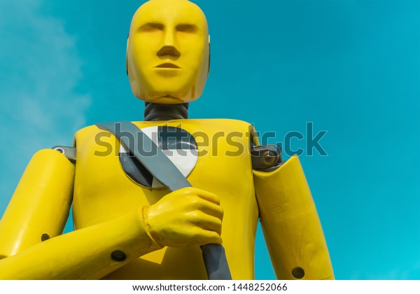 yellow crash test\
dummy on aqua sky\
background