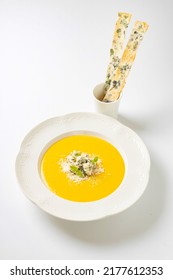 Yellow Cream Cheese Soup In A White Plate