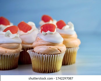 Yellow Cupcakes With Orange And White Swirled Frosting Piled High And An Orange Gum Drop Candy On Top.  Orange Creamsicle Cupcake, Delicious Baked Goods.