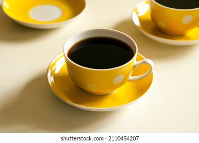 yellow cups with black tea. retro tea-set. vintage mug and plate
