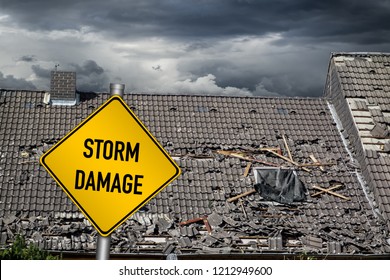 yellow damage warning sign in front of roof of house damaged by heavy hurricane tornado storm - Shutterstock ID 1212949600