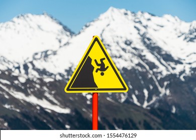 Yellow Danger Sign In The Mountains. Hiking Safety Warning.