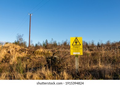 Yellow Danger Sign Warning Of Overhead Electrical Power Lines And Risk Of Death