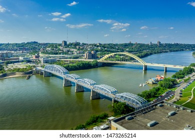 The Yellow Daniel Carter Beard Bridge And The Purple People Bridge In Cincinnati Ohio Over The Ohio River With Blue Sky