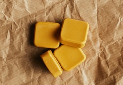 Yellow And Dark Blue Handmade Soap On Brown Packing Paper