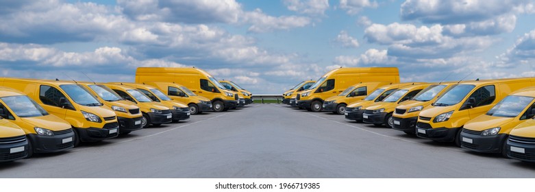 Yellow delivery vans parked in a rows