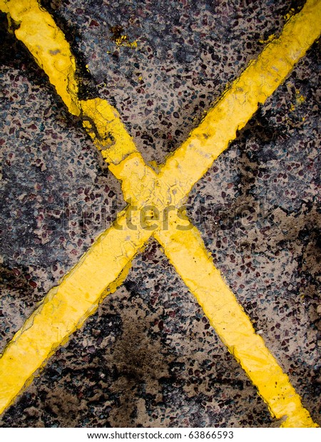 Yellow diagonal lines on\
pavement pattern  Yellow lines and weather make unikue pattern for\
pavement