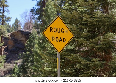 A Yellow Diamond Shape Rough Road Sign.