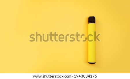 Yellow disposable electronic cigarette on bright yellow background