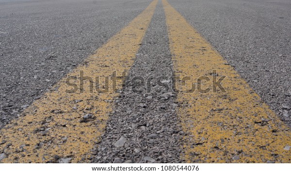 the yellow divider\
lines on a US road