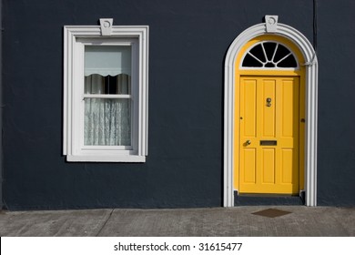 yellow door, white windows, black wall