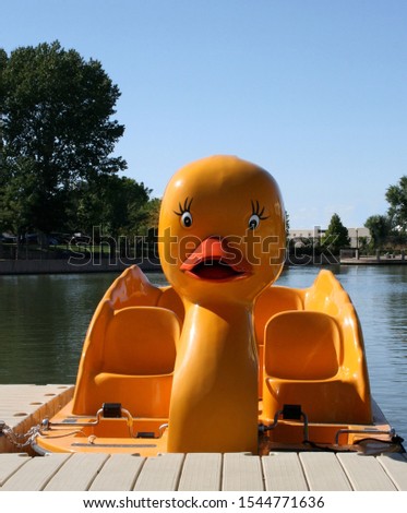 Yellow duck water paddle boat at dock on lake