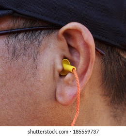 Yellow Ear Plug Into The Ear.