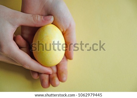 Yellow Easter egg in the Palm of your hand. Easter holiday
