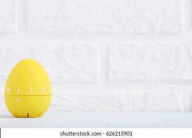 Yellow Egg Timer On A Brick Wall Background