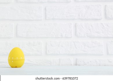 Yellow Egg Timer On A Brick Wall Background