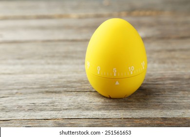 Yellow Egg Timer On Grey Wooden Background