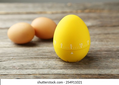 Yellow Egg Timer On Grey Wooden Background