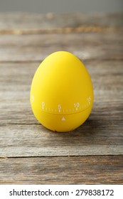 Yellow Egg Timer On Grey Wooden Background