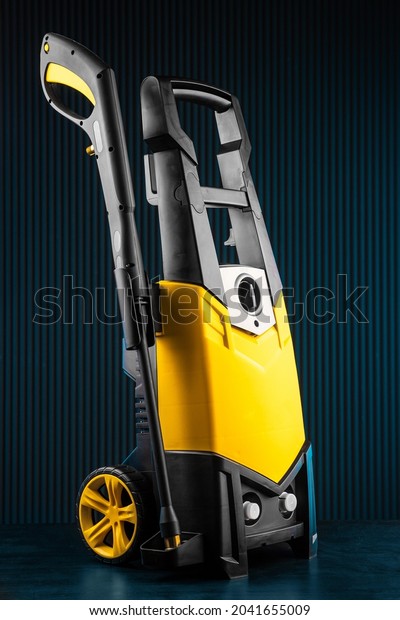 yellow\
electric pressure washer on blue\
background