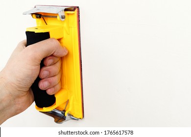 The Yellow Emery Cloth Holder In Hand On White Background