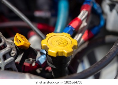 Yellow Engine Oil Cap Of A Car Is Seen Under The Hood.