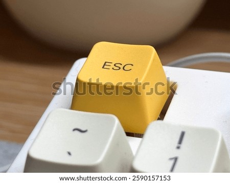 Yellow esc button at close range on mechanical keyboard for programmer