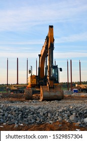 Yellow excavator at a construction site on the background of a standing object. - Shutterstock ID 1529857304