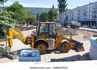 yellow excavator standing on the construction site