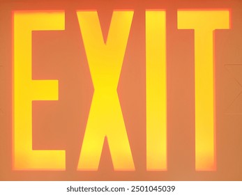 Yellow exit sign with orange letters - Powered by Shutterstock