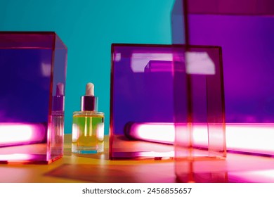 yellow face oil in glass bottle with dropper on yellow and blue background with pink and purple geometric elements and neon light. Bright fun minimalist summer skincare concept - Powered by Shutterstock