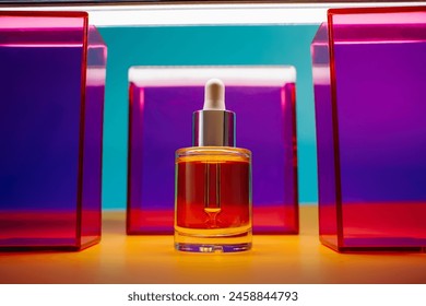 yellow face oil in glass bottle with dropper on yellow and blue background with pink and purple geometric elements and neon light. Bright fun minimalist summer skincare concept - Powered by Shutterstock