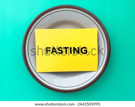 Yellow Fasting Note on Plate Symbolizing Nutrition and Health Concepts