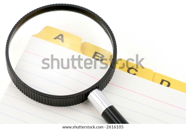 yellow file divider and magnifier, office supplies,\
close up