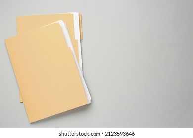 Yellow files with documents on light grey background, top view. Space for text - Shutterstock ID 2123593646