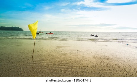 Yellow flag on the shore with beach background - Powered by Shutterstock