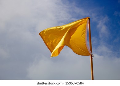 Yellow flag waving in the wind - Powered by Shutterstock