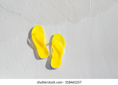 Yellow Flip Flops On The Beach