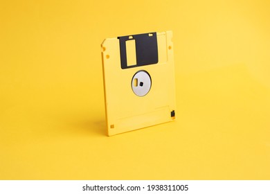 Yellow floppy disk on yellow background. - Shutterstock ID 1938311005
