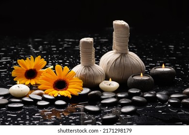 yellow flower , and  candle ,spa ball and zen black stones on wet background